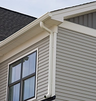 Vinyl siding and gutter installation on home exterior
