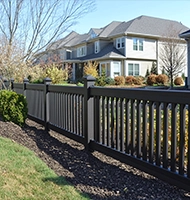 Black privacy fence installed along residential yard