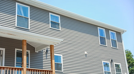 Vinyl siding installation on modern residential home